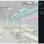 Interior view of an industrial piping manufacturing facility with color-coded HVAC ducts and heavy machinery.